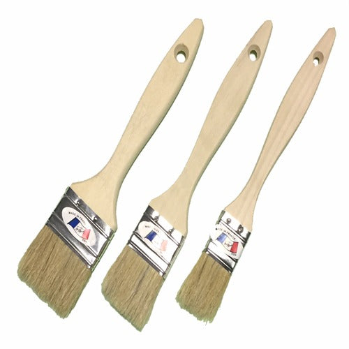 Trois pinceaux plats à manche en bois clair, poils beiges et virole métallique, de tailles différentes