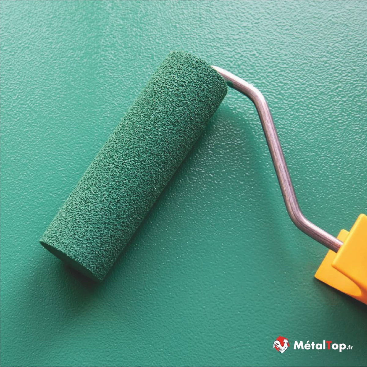 Rouleau à peinture vert foncé peignant une surface métallique verte texturée
