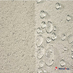 Gouttes d'eau sur une surface texturée beige, vue rapprochée