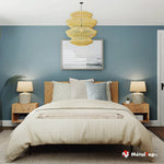 Chambre bleu-gris avec lit en bois, linge crème, suspension jaune en osier et chevets en bois