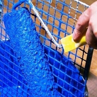 Rouleau à peinture bleue chargé de peinture épaisse sur une grille, pinceau jaune